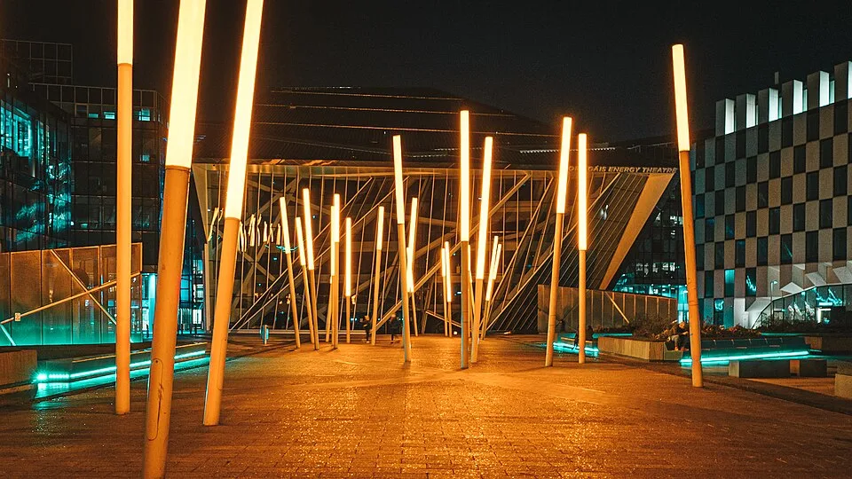 The Bord Gáis Energy Theatre at Grand Canal Dock, Dublin 2, lit up at night — a short walk from EirStay serviced apartments