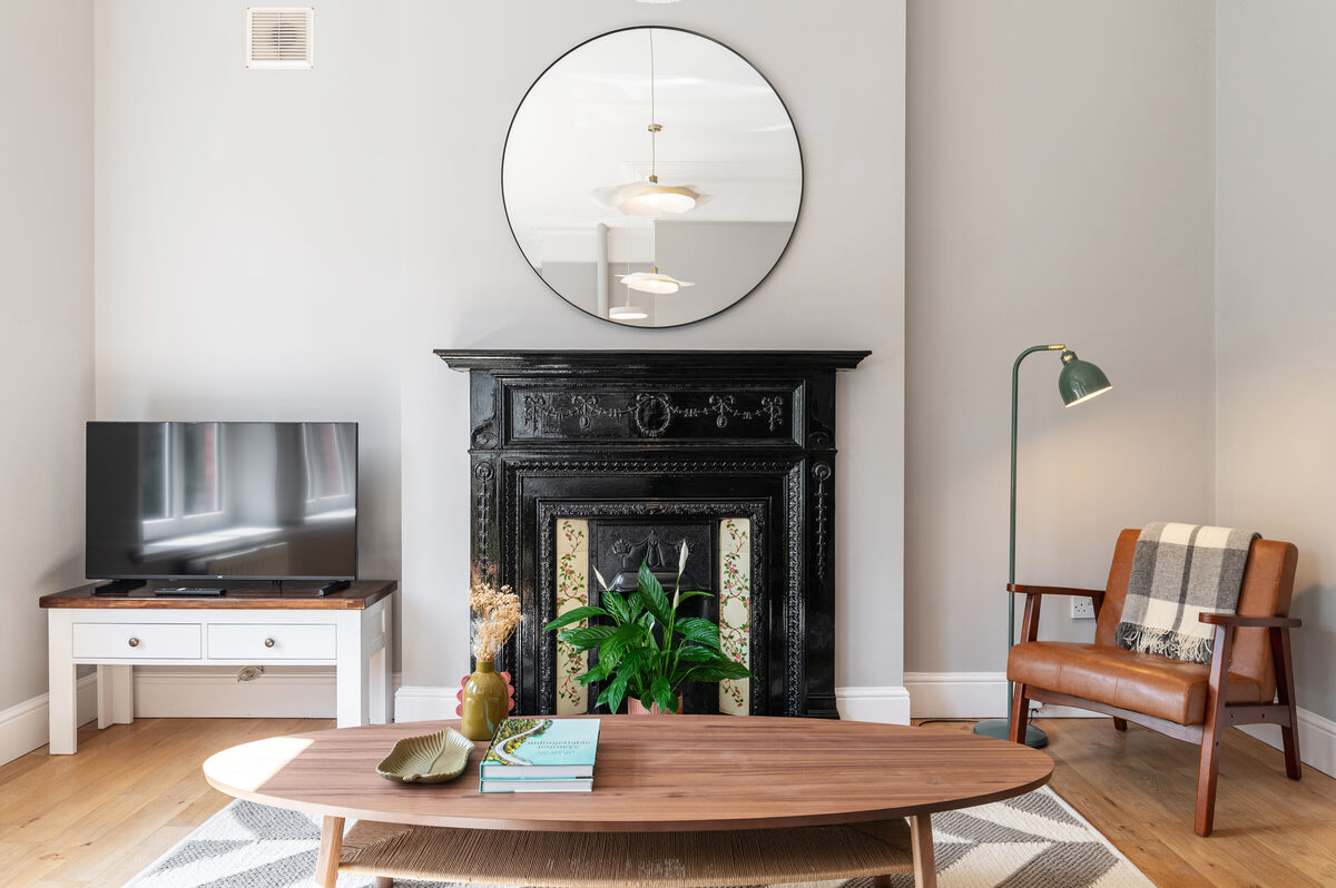 EirStay serviced apartment living area with Victorian fireplace and smart TV Donnybrook Dublin 4