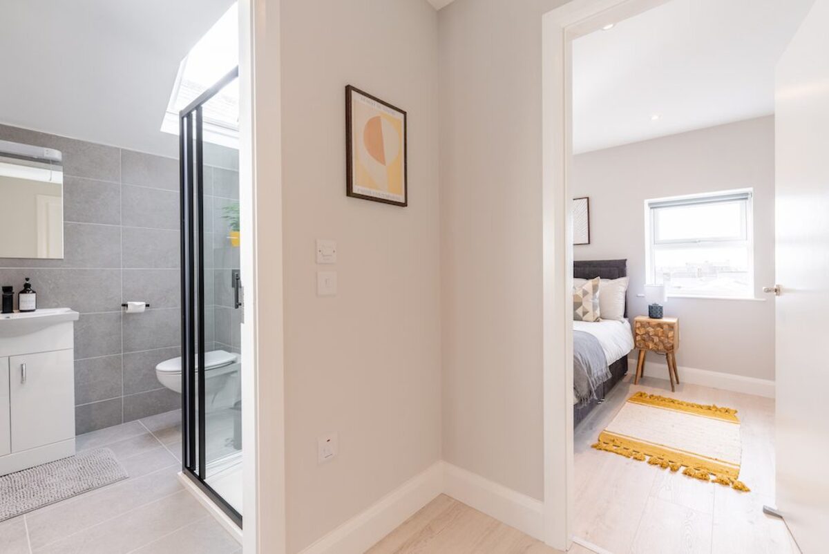 Hallway connecting bathroom with walk-in shower and bedroom in EirStay corporate short stay apartment Camden Street Dublin 2