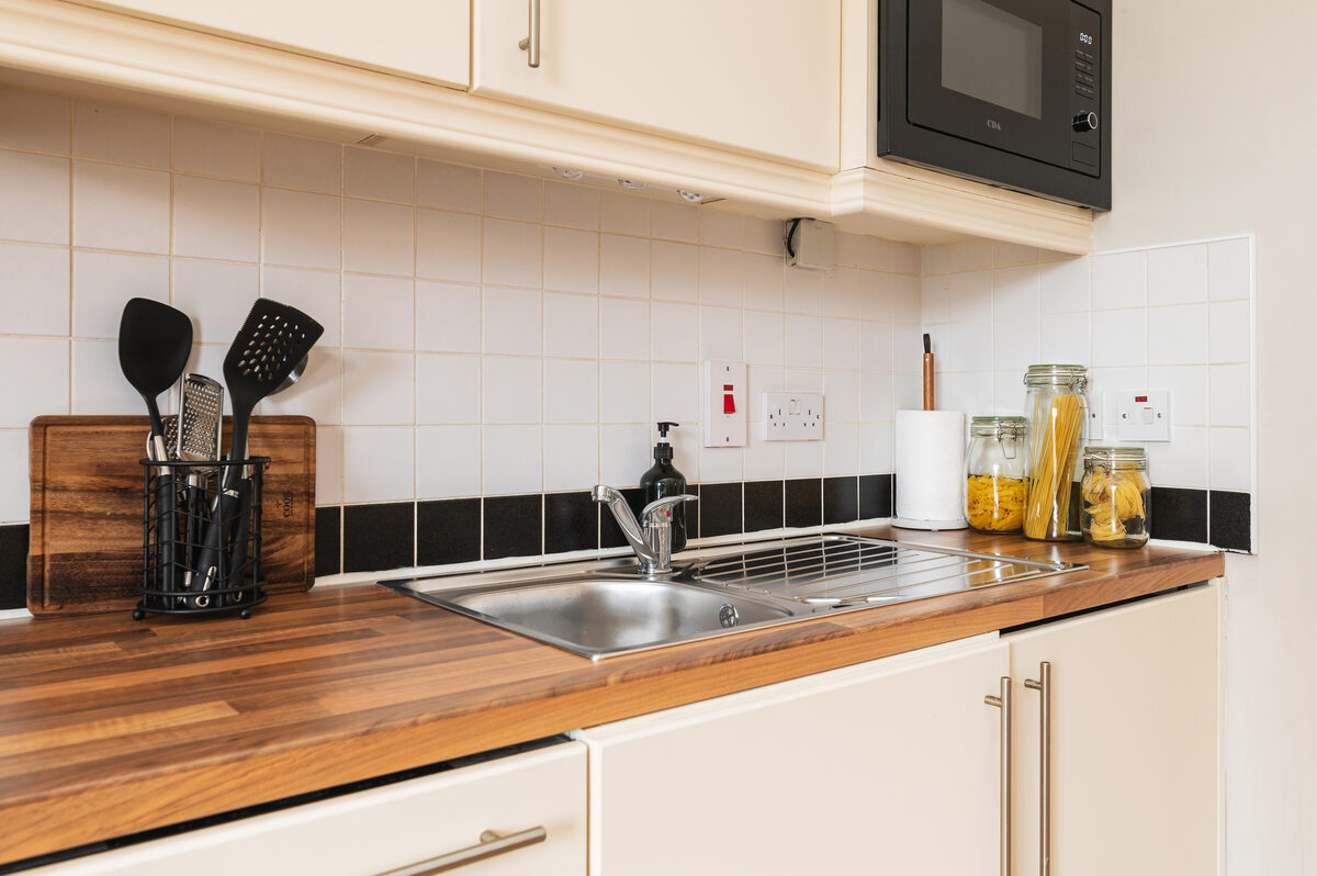 Kitchen worktop with utensils and sink in EirStay short stay corporate serviced apartment Donnybrook Dublin 4