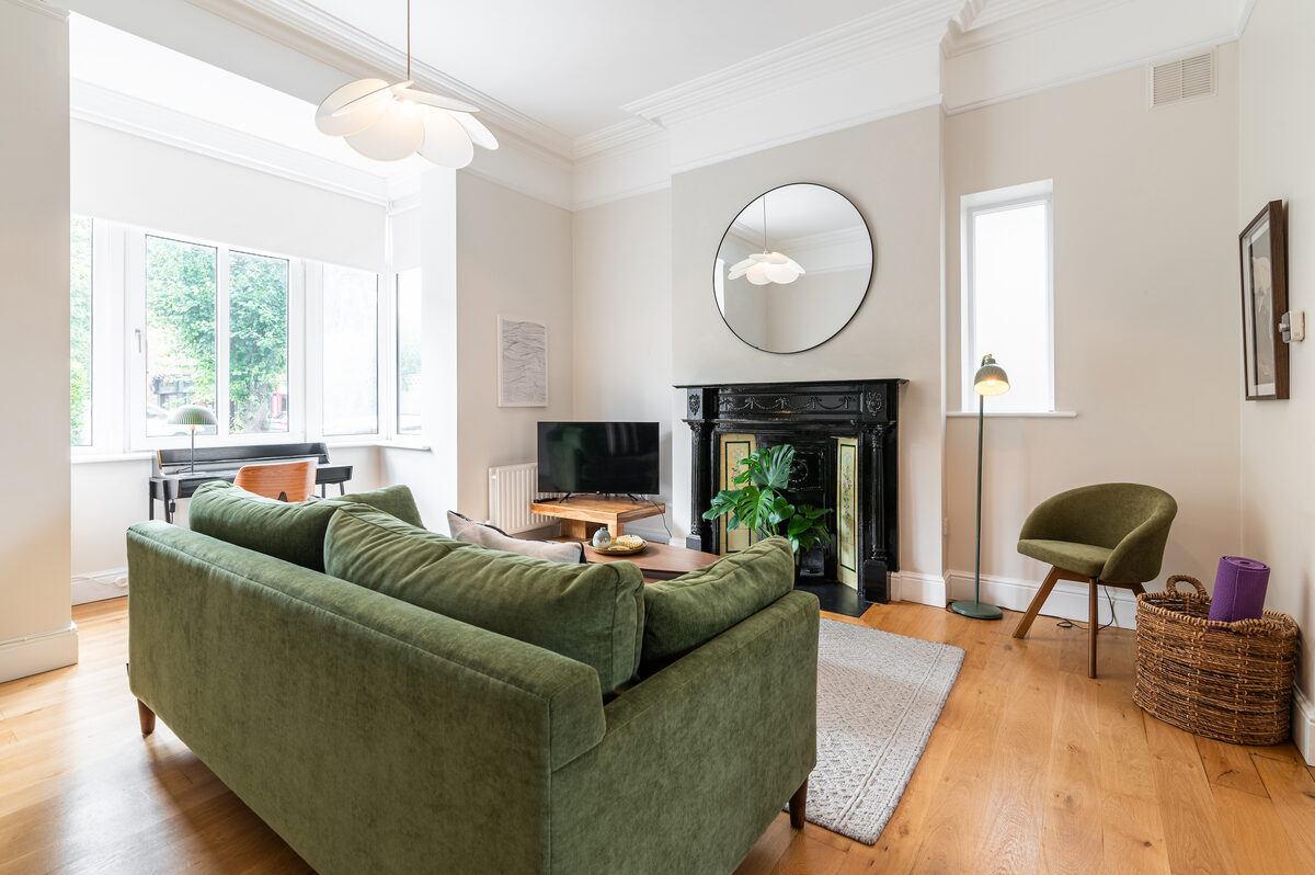 Bright living area with Victorian fireplace and smart TV in EirStay corporate short stay apartment Dublin 4
