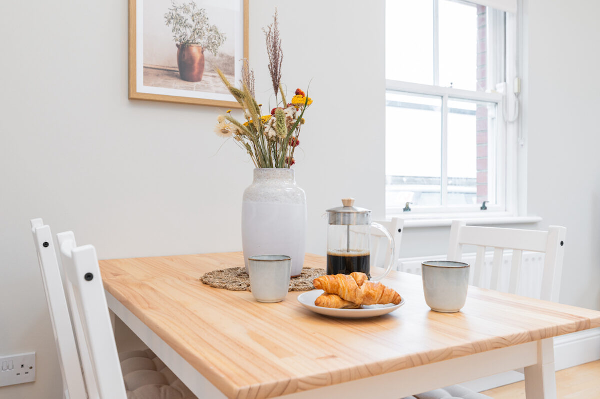 Dining area with fresh flowers and morning coffee setup in EirStay corporate accommodation Donnybrook Dublin 4