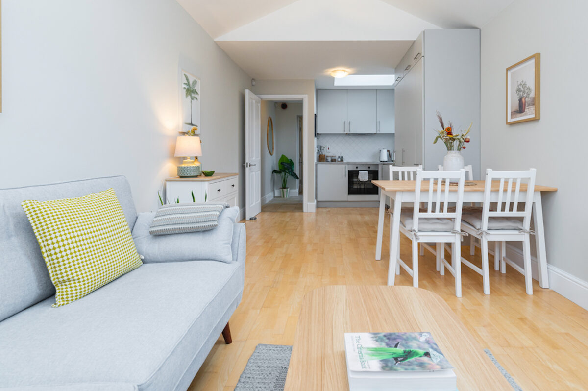 Open plan living room flowing into kitchen and dining in EirStay corporate short stay apartment Donnybrook Dublin 4