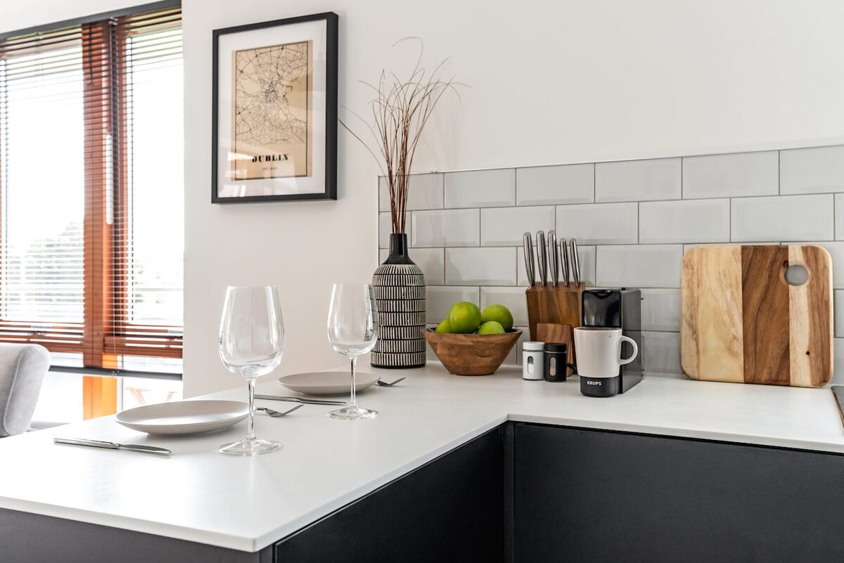 Kitchen countertop with Dublin map print wine glasses Krups coffee maker and chopping boards in EirStay corporate short stay Kilmainham Dublin 8
