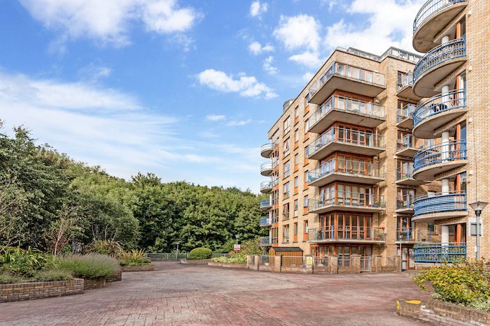 Modern apartment building exterior with curved balconies and landscaped grounds in EirStay serviced apartment complex Kilmainham Dublin 8