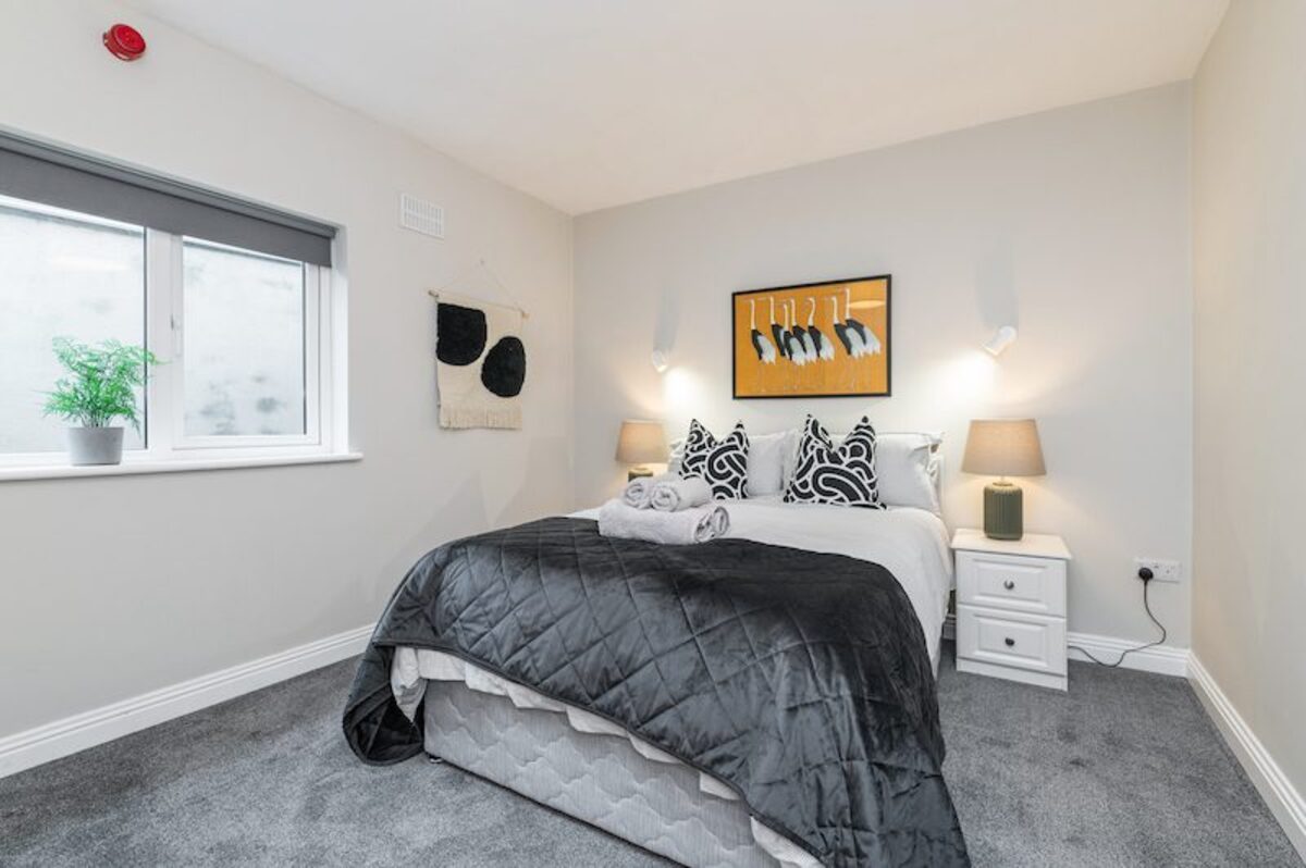 Master bedroom with premium bedding and bedside lamps in EirStay corporate stays apartment Ranelagh Dublin 6
